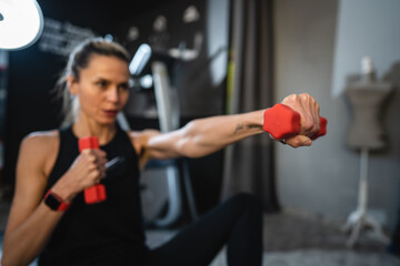Fototapeta premium mature caucasian woman slim female use dumbbell weights for training