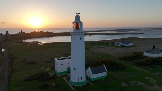 Drone video of Hurst Lighthouse in Hampshire, England. Beautiful UK lighthouse at sunset.