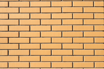 Yellow brick wall background texture, full frame. Modern new brick.