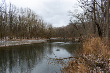 Fototapeta na wymiar River through winter forest.