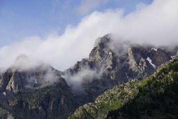 mountains in the fog by the snowy peak in the southern Alps, France