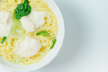 Chinese cuisine shrimp wonton dumpling noodle soup food in white bowl on white table background