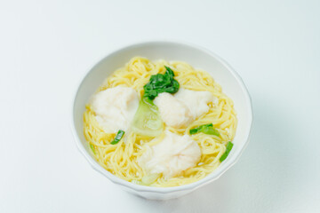 Chinese cuisine shrimp wonton dumpling noodle soup food in white bowl on white table background