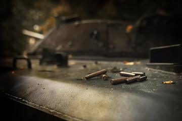 Toned photograph. A selective focus shot of an abandoned military tank in forest