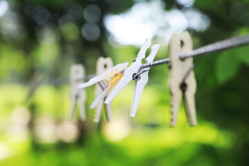 Clothespins on a clothesline in summer. Dry clothes outside. Clothes on a rope.