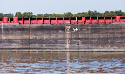 Hull of a bulk carrier ship with draft scale, background photo