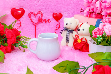 White creamer mug on the top of a fluffy pink carpet surrounded by valentine themed decorations