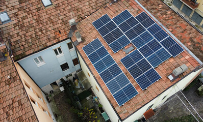 Aerial top down view of solar panels modules mounted on roof. Solar power station from drone view. Alternative energy concept. Bologna, Italy. © Claudio Caridi