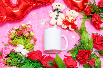 Obraz na płótnie Canvas White blank coffee mug on the top of a fluffy pink carpet surrounded by valentine themed decorations