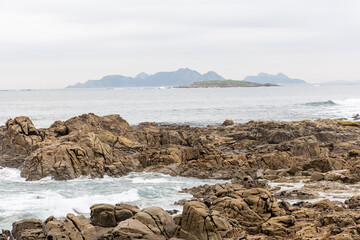 waves crashing against the rocks in the atlantic ocean in the town of Baiona, Galicia, Spain