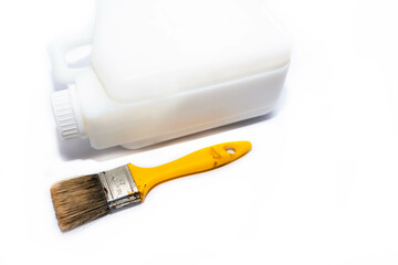 Used 40 mm paint brush, plastic container with white paint isolated on white background, space for text.