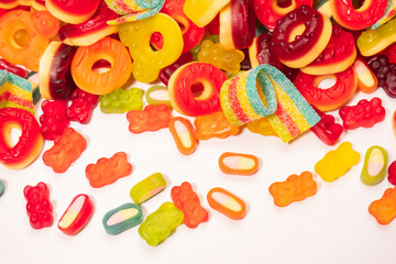 Fototapeta na wymiar Assorted colorful gummy candies. Top view. Jelly donuts. Jelly bears. Isolated on a white background.