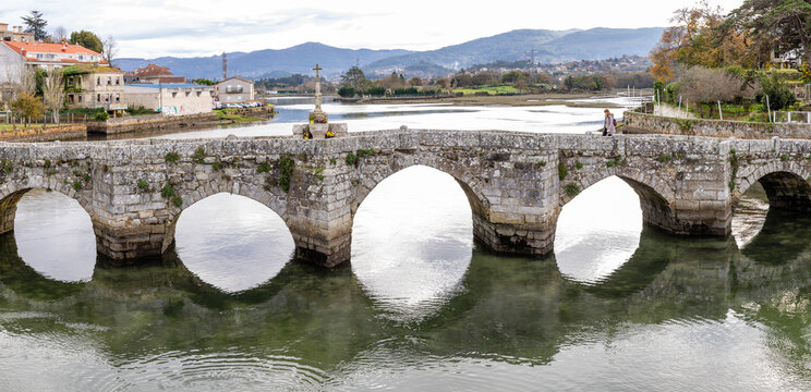 Baiona, Spain - December 05, 2022: Romanesque bridge of La Ramallosa that connects the towns of Nigran and Baionan in the town of Baiona, Spain