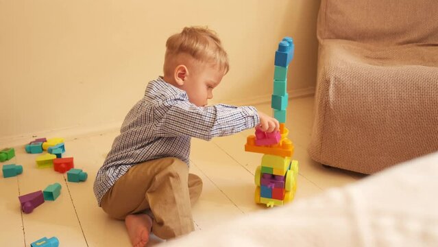 the father is playing with the boy in the constructor. father plays with his son in the constructor