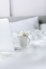 Fototapeta na wymiar Christmas cup with fully marshmallows on white bed