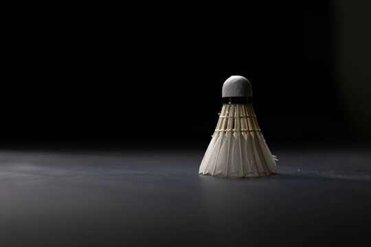 Slow motion of a Shuttlecock falling on a black background. Black background.