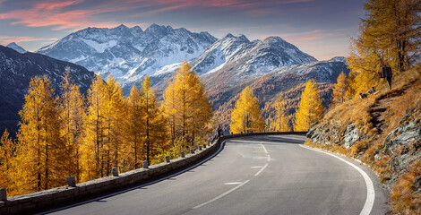 Mountain road. Beautiful asphalt road in the evening in Autumn during sunset. Vintage toning. Highway in mountains. Grossglockner High Alpine Road. Austria. Travel adventure and freedom concept.
