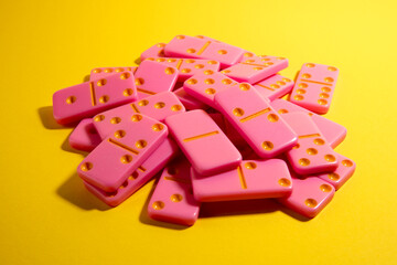 Pink board game domino on a yellow background