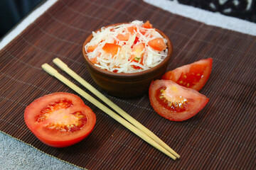Tomatoes, lettuce and mackerel on a wooden table.