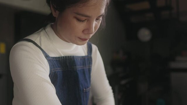 Close-up face of Asian Women thresh dough at home