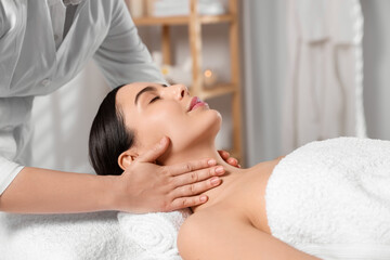 Fototapeta na wymiar Beautiful woman receiving massage in beauty salon, closeup