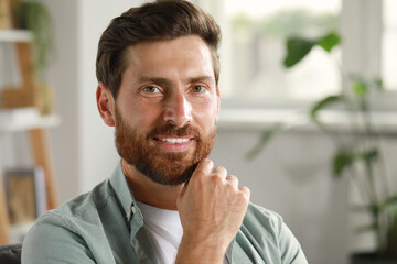 Naklejka premium Portrait of handsome bearded man at home, space for text