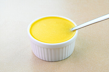 Closeup view of ghee in a bowl. Ghee is clarified butter used in asian cooking.
