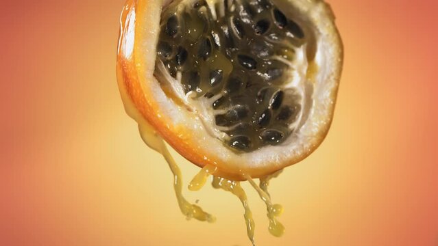 Slow Motion Macro Shot of Flowing Granadilla Juice from Halved Granadilla