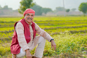 Indian farmer giving expression at agriculture field.