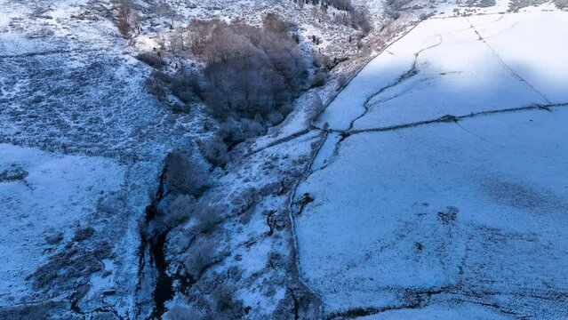 Snowy landscape of cabins and meadows in Puerto de los Tornos, between Cantabria and Burgos. Aerial view from a drone. Castile and Leon, Spain, Europe