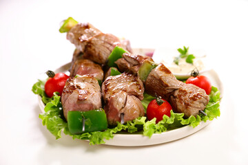 grilled meat barbecue and salad on plate isolated on white background
