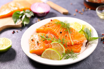 Salmon fillet and herbs isolated on white background