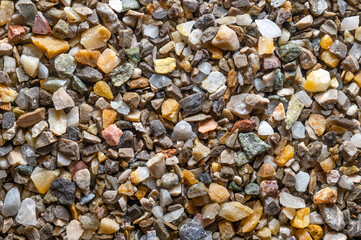 Moist road and plaster grit, loose chippings, crushed stone, surface, from above. Lime- and...