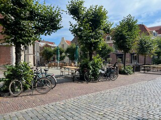 Fototapeta na wymiar City street with beautiful buildings, plants and bicycles