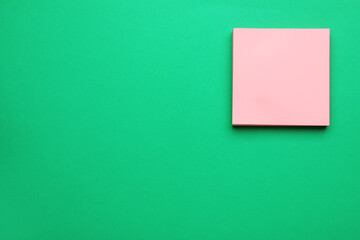 Empty notes on green background, top view. Space for text