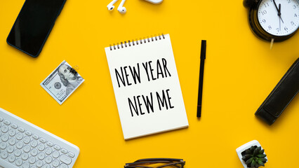 New year new me text in open notepad on yellow background. Setting goals and new years resolution. New year loading.
