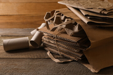 Different waste paper on wooden table, closeup