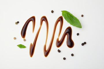 Organic balsamic vinegar, peppercorns and basil leaves on white background, flat lay