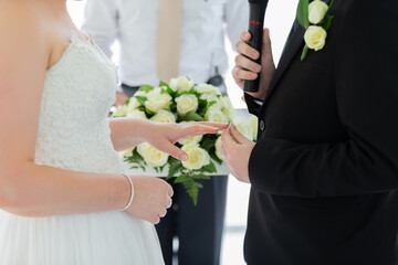 The bride is waiting for the groom wearing a diamond ring. to perform the engagement ceremony at...