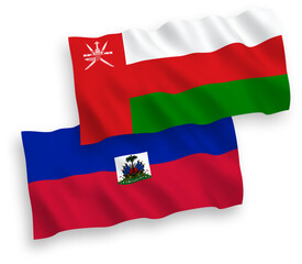 National vector fabric wave flags of Sultanate of Oman and Republic of Haiti isolated on white background. 1 to 2 proportion.