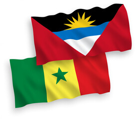 National vector fabric wave flags of Republic of Senegal and Antigua and Barbuda isolated on white background. 1 to 2 proportion.