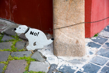 Prohibition sign. Plywood image of dog taking a crap