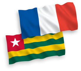National vector fabric wave flags of France and Togolese Republic isolated on white background. 1 to 2 proportion.