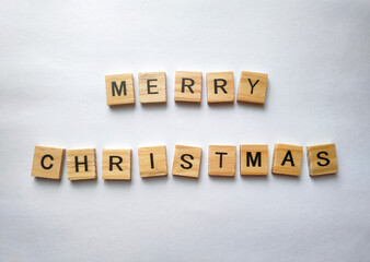 Merry Christmas wooden letters on white background. 