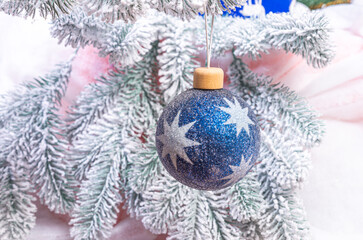 Fototapeta na wymiar Creative diy craft hobby. Making handmade craft christmas ornaments and balls with felt spruce tree. christmas tree with colorful balls and gift boxes over white brick wall with blue and white balls