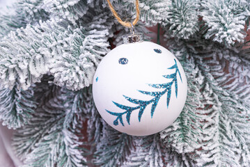 Creative diy craft hobby. Making handmade craft christmas ornaments and balls with felt spruce tree. christmas tree with colorful balls and gift boxes over white brick wall with blue and white balls