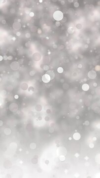 Abstract glitter lights gray background. Seamless looping video footage. (018_warm gray_vertical)