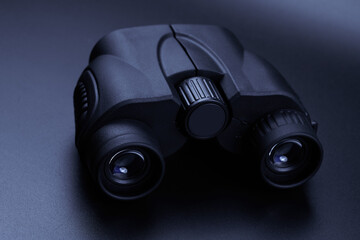 New binoculars isolated on black background. Flat lay, top view