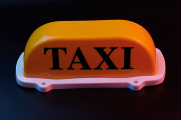Yellow taxi sign for car roof isolated on black background