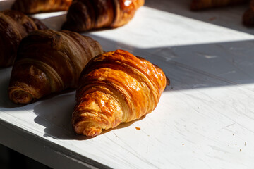 Freshly baked crispy delicious croissant on the table 